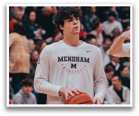 A man holding a basketball in a gym with a crowd of people watching. AI generated content