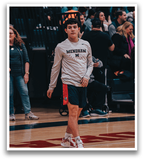 A man wearing a Mendham shirt is walking on a basketball court. AI generated content