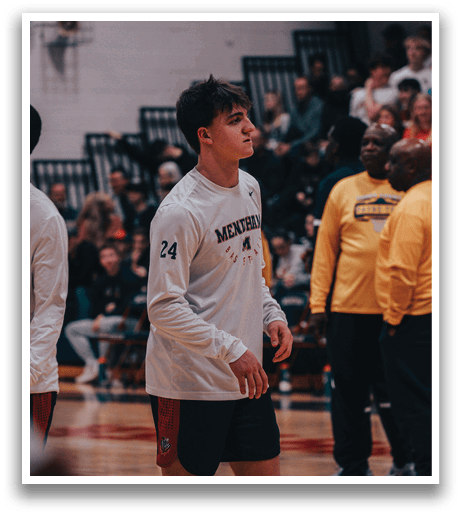 A man wearing a white shirt with the number 24 stands on a basketball court. AI generated content