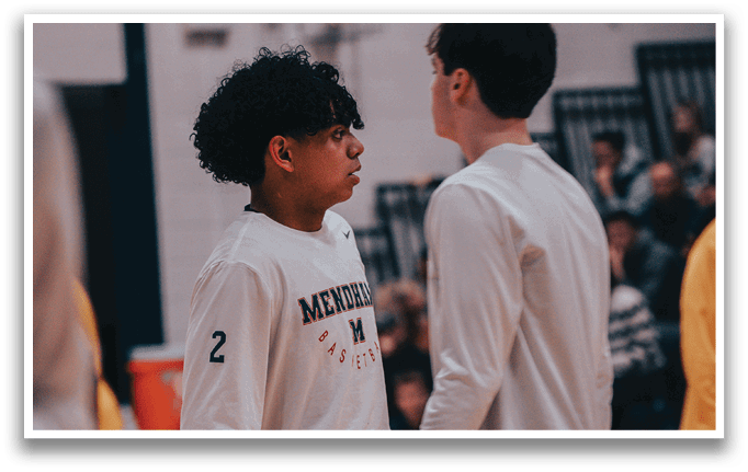 Two young men wearing white shirts and shorts are standing on a basketball court. AI generated content