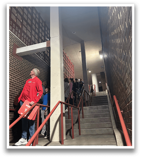 A group of people are standing on a staircase, waiting to go up. AI generated content