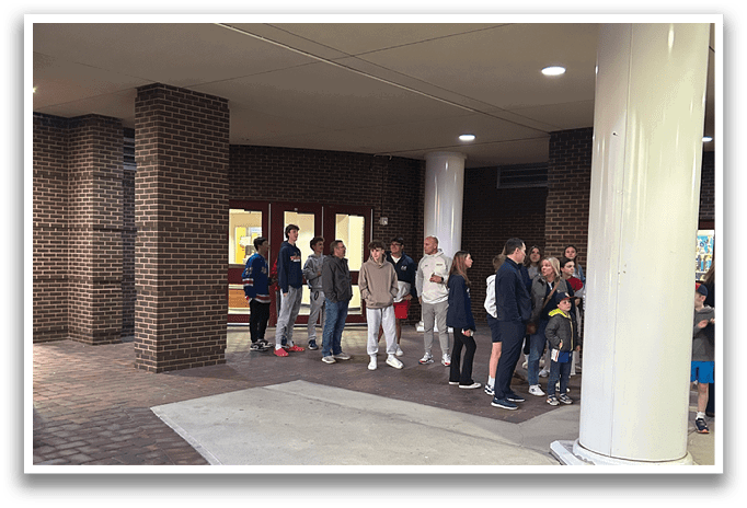 A group of people are standing in a hallway, waiting to enter a building. AI generated content