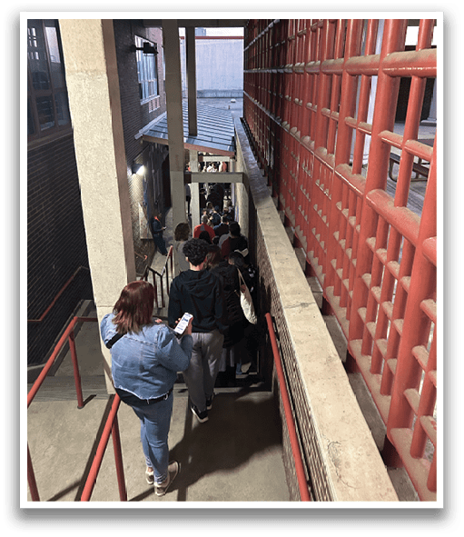 A group of people are waiting in line to enter a building. AI generated content
