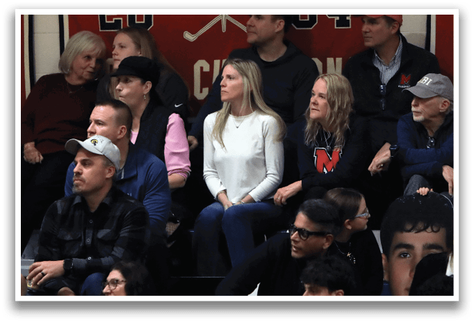 A group of people are sitting in the stands at a sporting event. AI generated content