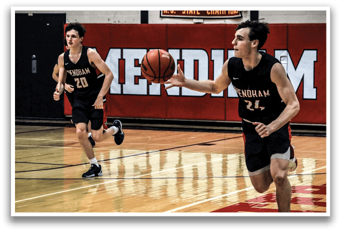 Two men playing basketball, one holding a basketball and the other running. AI generated content