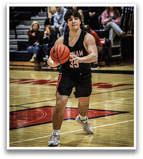 A man wearing a basketball uniform is holding a basketball on a court. AI generated content