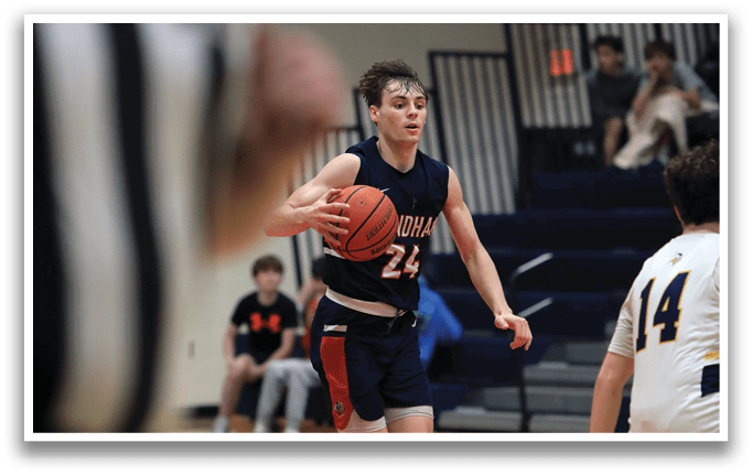 A basketball player wearing a blue uniform with the number 24 on it is holding a basketball and running on the court. AI generated content