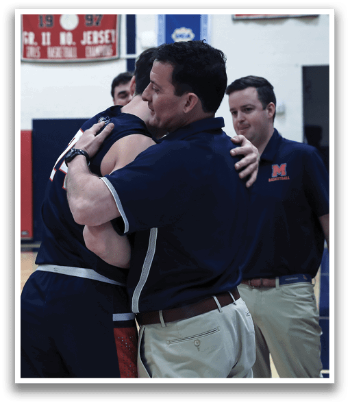 Two men hugging on a basketball court, with one man wearing a blue shirt and the other wearing a black shirt. A third man, wearing a blue shirt, stands nearby. AI generated content