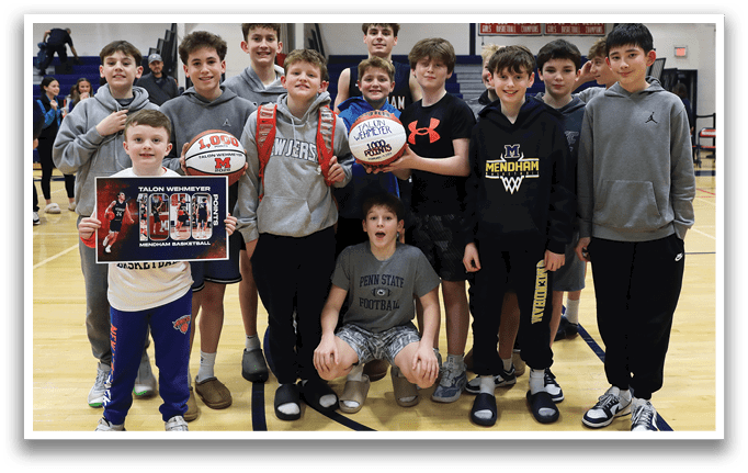 A group of young boys posing for a picture on a basketball court. AI generated content