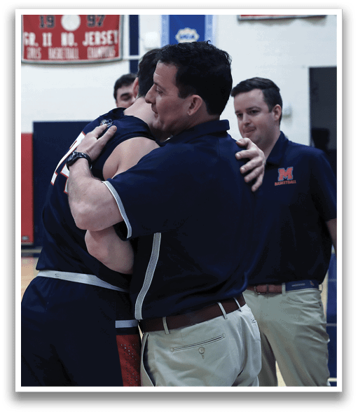 Two men hugging on a basketball court, with one man wearing a blue shirt and the other wearing a black shirt. A third man, wearing a blue shirt, stands nearby. AI generated content