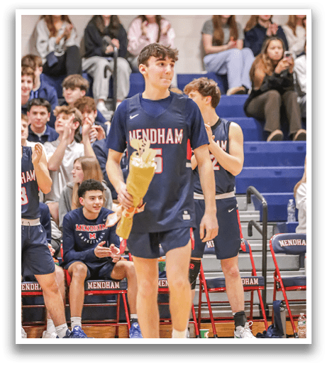 A man in a blue shirt and shorts holds a trophy while standing on a basketball court. AI generated content
