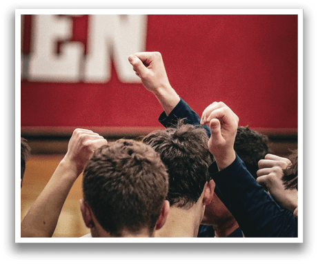 A group of men are huddled together, with their arms around each other, in front of a red and white banner. AI generated content