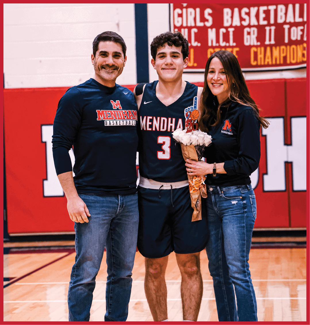 A man, woman, and boy pose for a photo in a gym. The man is wearing a blue shirt and holding a bouquet of flowers. AI generated content