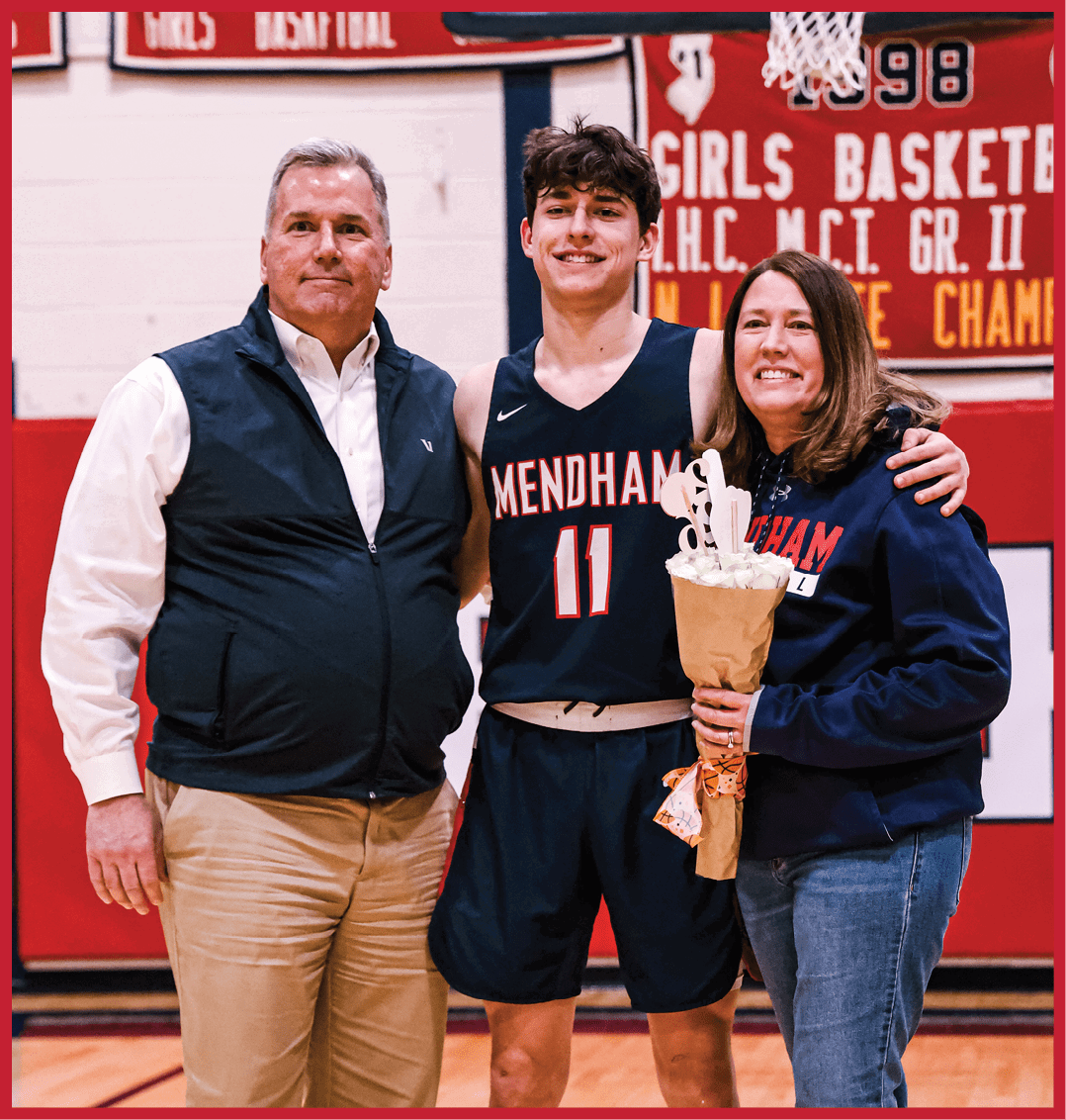 A man and woman pose with a basketball player in front of a banner. AI generated content