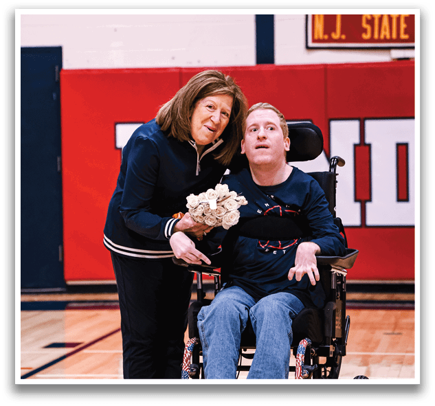 A woman and a man in a wheelchair are holding flowers. AI generated content