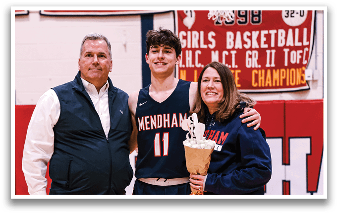 A man and woman pose with a basketball player in front of a banner. AI generated content