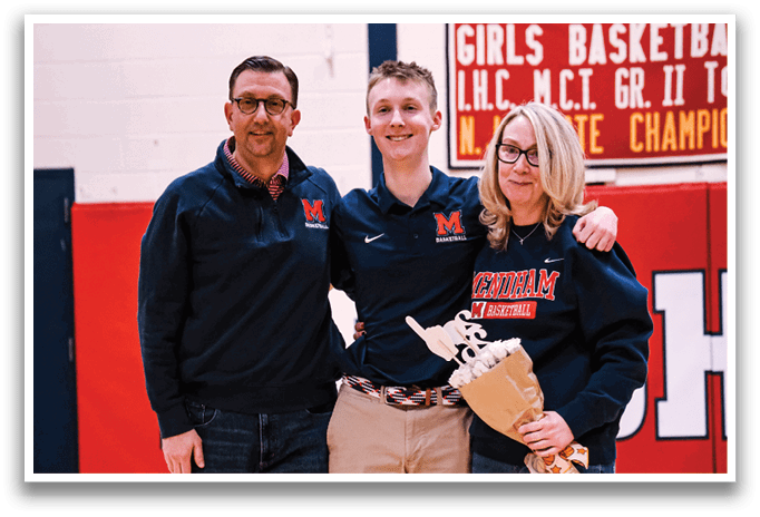 A man and woman pose with a boy in a gym. The woman is holding a bouquet. AI generated content