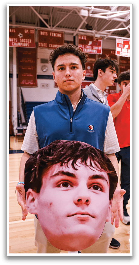 A man wearing a blue vest holds a cardboard cutout of another man's face. AI generated content