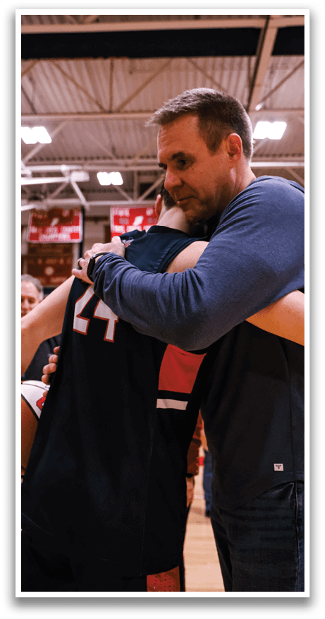 Two men hugging each other, one of them holding a basketball. AI generated content