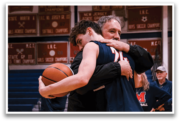 Two men hugging on a basketball court, one holding a basketball. AI generated content