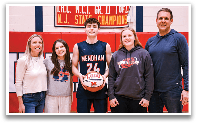 A group of people, including a man holding a basketball, pose for a photo. AI generated content