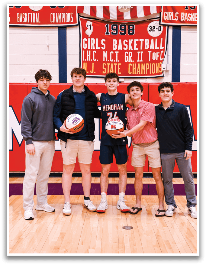Four young men pose for a photo with basketballs in their hands. AI generated content