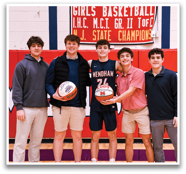 Four boys are standing on a basketball court holding a basketball. AI generated content