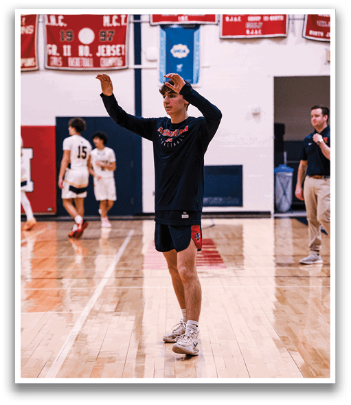 A man wearing a black shirt and white shoes is standing on a basketball court. AI generated content