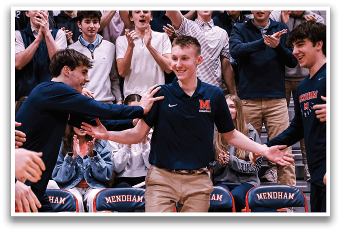 A group of people are on a basketball court, with one man standing in the center holding his arms up. The crowd is cheering him on. AI generated content