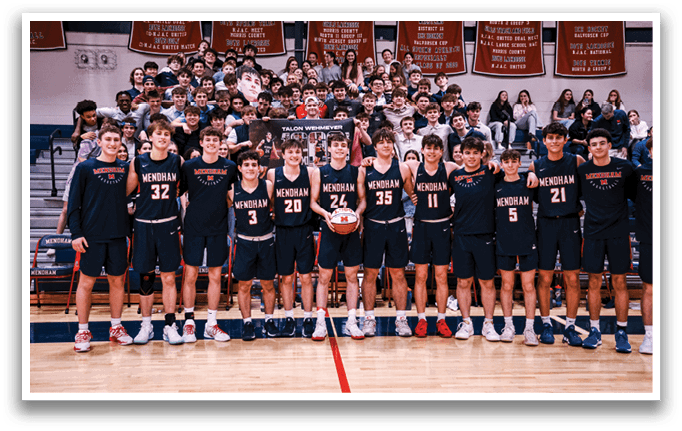 A group of young men pose for a photo on a basketball court. AI generated content