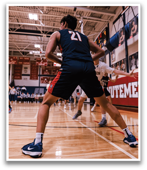 A basketball player wearing a black jersey with the number 22 on it is playing on the court. AI generated content