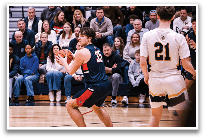 A basketball game is taking place with a crowd of people watching. A man is holding a basketball and getting ready to shoot it. AI generated content
