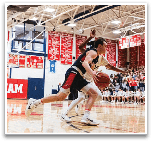 Two basketball players are running for the ball, one with a white shirt and the other with a blue shirt. The players are in motion, with one player reaching for the ball. The scene takes place on a basketball court, with a crowd of people watching the game. AI generated content
