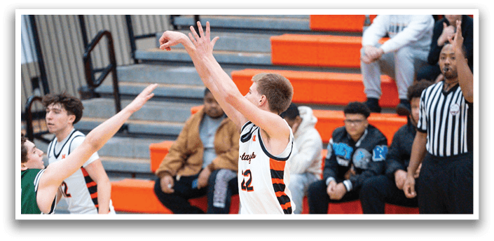 Basketball players on a court, one of them jumping to shoot the ball. AI generated content