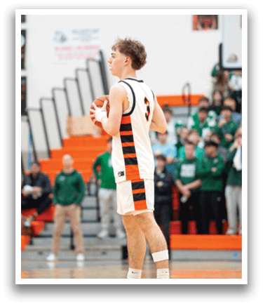 A basketball player wearing a white and orange jersey stands on the court holding a basketball. AI generated content