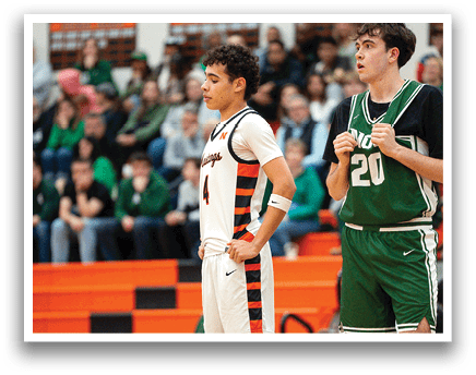 Two basketball players are standing on the court, one wearing a white jersey and the other wearing a green jersey. They are both holding their hands on their hips. AI generated content