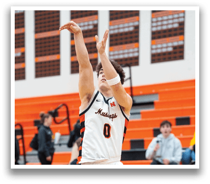 A basketball player is jumping in the air to shoot the ball. Contenido generado con IA