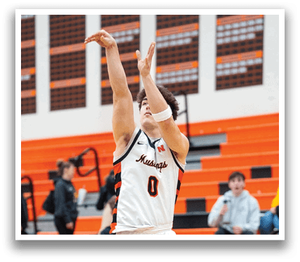 A basketball player is jumping in the air to shoot the ball. Contenido generado con IA
