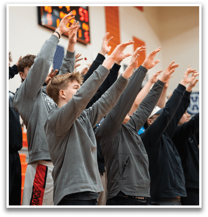 A group of people are standing in a line, with their hands raised in the air. Contenido generado con IA