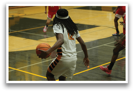 A basketball player in a white and orange uniform is running with a basketball in his hand. AI generated content