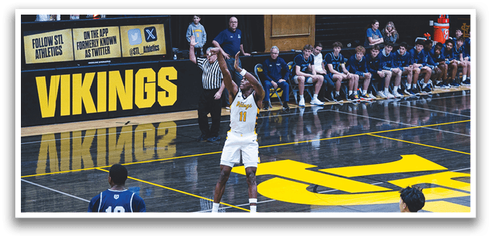 A basketball game is taking place in a gymnasium with a crowd of people watching. A player is in the process of shooting the ball, while another player is running to defend. The scene is filled with excitement and anticipation as the players compete against each other. AI generated content