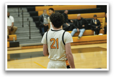 A basketball player wearing a white jersey with the number 21 on it is standing on the court. AI generated content