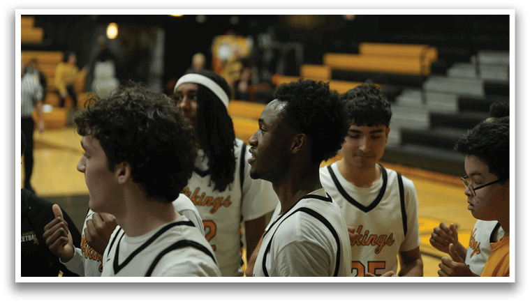 A group of young men wearing black and white uniforms stand on a basketball court. AI generated content