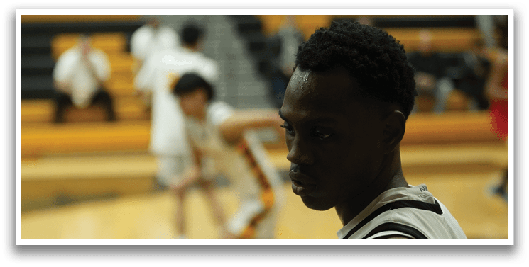 A basketball player wearing a white shirt and black shorts stands on the court. AI generated content