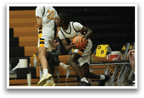 A group of men are playing basketball in a gym. One man is holding a basketball while another man is running towards him. AI generated content