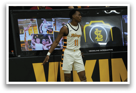 A man in a basketball uniform is standing in front of a scoreboard. AI generated content