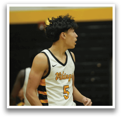 A man wearing a jersey with the number 5 on it is standing on a basketball court. AI generated content
