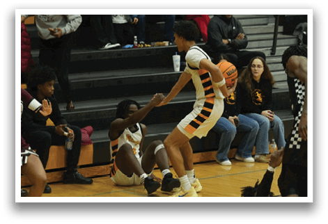 A group of cheerleaders are performing in front of a crowd of people. AI generated content