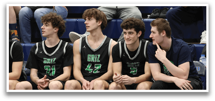 A group of young men wearing basketball uniforms are sitting on a bench. AI generated content