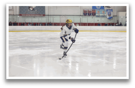 A woman wearing a white uniform is skating on the ice with a hockey stick. AI generated content